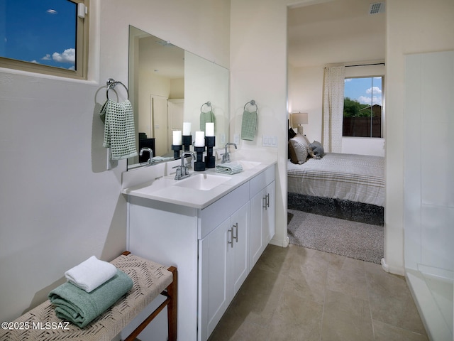 ensuite bathroom featuring double vanity, ensuite bath, visible vents, and a sink