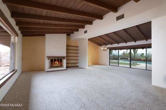 unfurnished living room featuring a large fireplace, visible vents, wooden ceiling, and lofted ceiling with beams