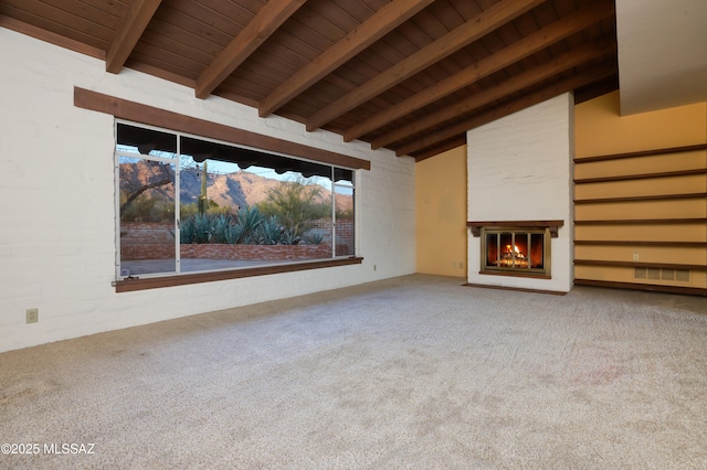 unfurnished living room with a glass covered fireplace, wood ceiling, carpet flooring, and vaulted ceiling with beams