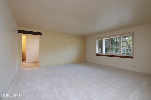 unfurnished room featuring light colored carpet