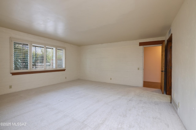 spare room with light carpet and visible vents