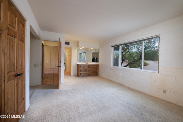 unfurnished bedroom featuring light colored carpet and visible vents