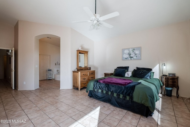 bedroom featuring light tile patterned floors, ceiling fan, arched walkways, and high vaulted ceiling