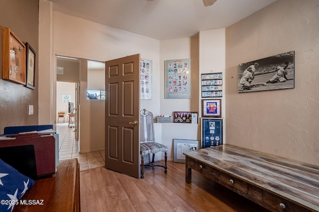 interior space featuring light wood-style flooring and a textured wall