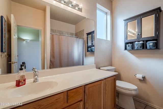 full bathroom featuring toilet, curtained shower, tile patterned flooring, and vanity