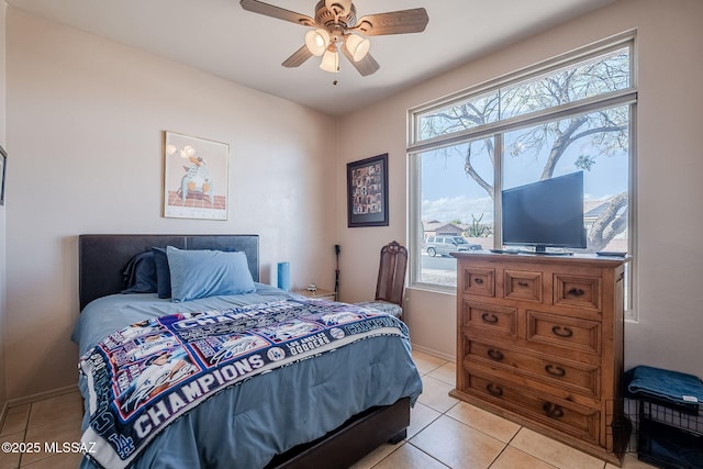 bedroom with a ceiling fan, baseboards, and light tile patterned floors