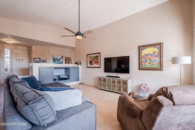 living area featuring ceiling fan, high vaulted ceiling, and visible vents