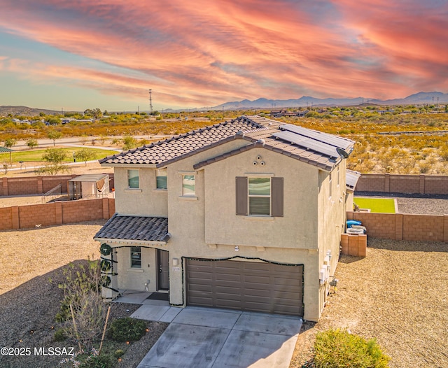 view of front of house with a garage and a mountain view