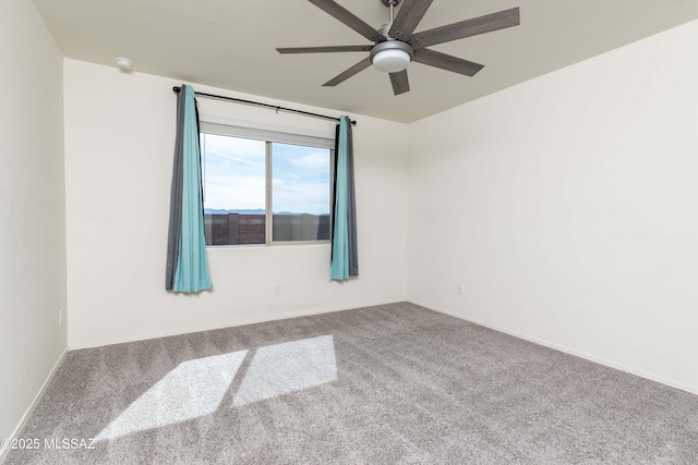 unfurnished room featuring ceiling fan and carpet flooring