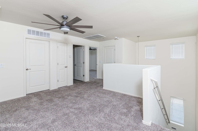 unfurnished room with ceiling fan and light colored carpet