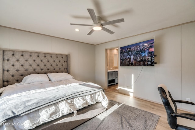 bedroom with ceiling fan, ornamental molding, ensuite bathroom, and light hardwood / wood-style floors