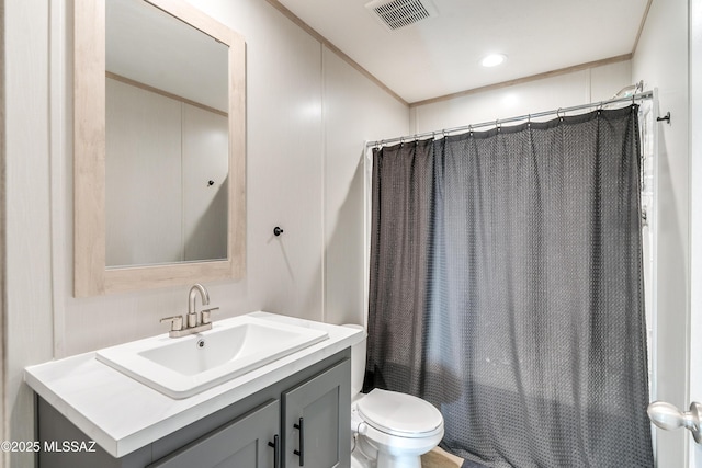 full bathroom with ornamental molding, vanity, shower / bathtub combination with curtain, and toilet