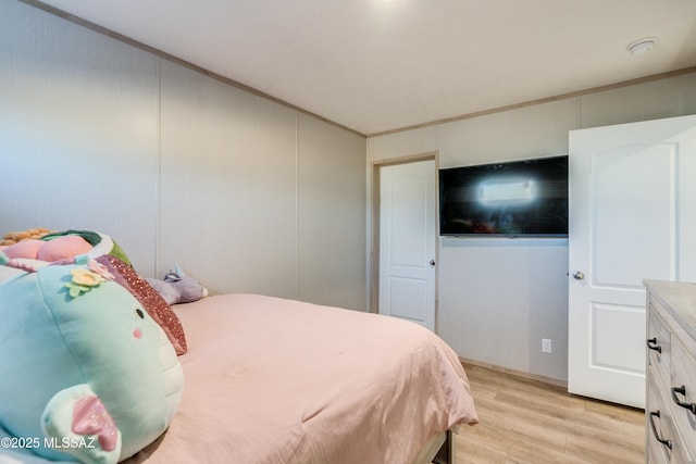 bedroom featuring light hardwood / wood-style flooring and ornamental molding