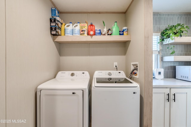 washroom with washing machine and clothes dryer