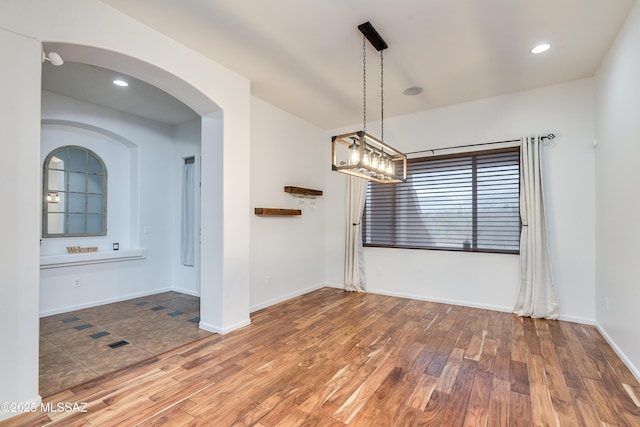 unfurnished dining area featuring recessed lighting, wood finished floors, and baseboards