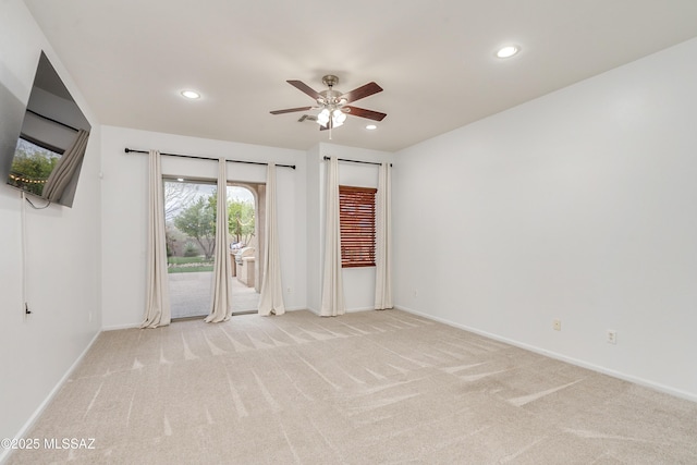 spare room featuring baseboards, ceiling fan, recessed lighting, and light colored carpet