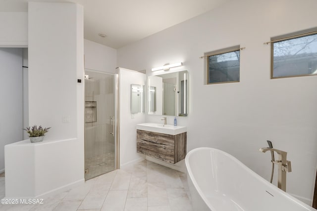 full bath with a freestanding tub, a stall shower, and vanity