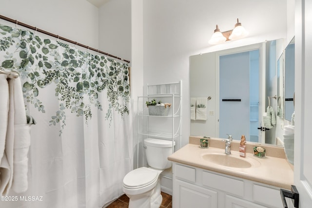 bathroom featuring toilet and vanity