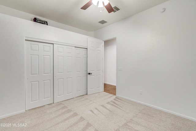 unfurnished bedroom featuring visible vents, light carpet, and baseboards