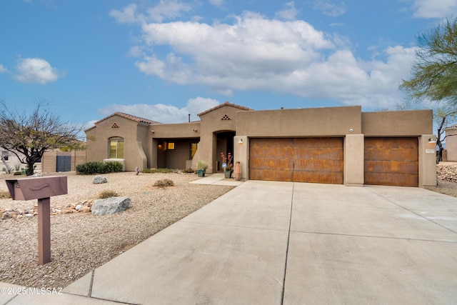 view of front facade featuring a garage, driveway, and stucco siding