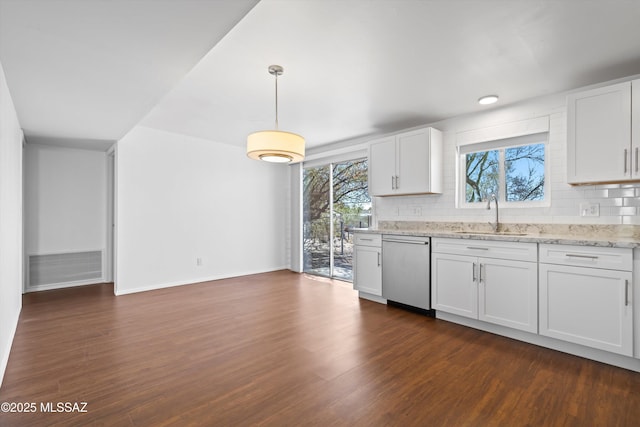 kitchen with a sink, dark wood-type flooring, backsplash, and stainless steel dishwasher