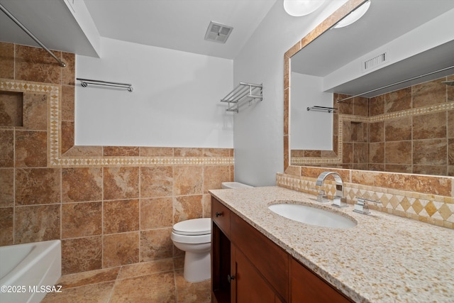 full bathroom featuring visible vents, tile walls, toilet, and walk in shower