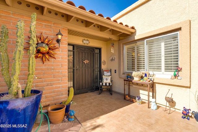 entrance to property with brick siding and stucco siding