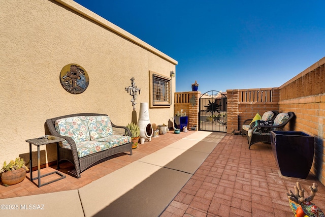 view of patio / terrace featuring a gate and fence