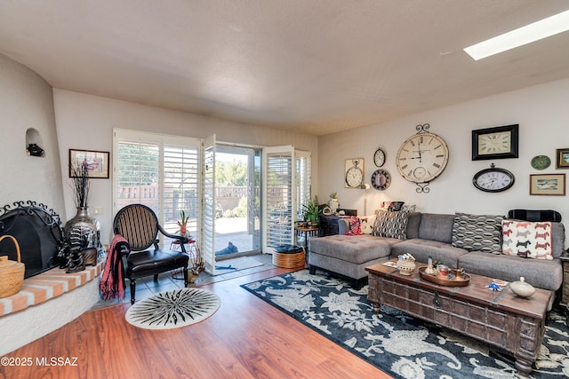 living area featuring a skylight and wood finished floors