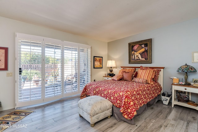 bedroom featuring access to outside and light wood-style floors