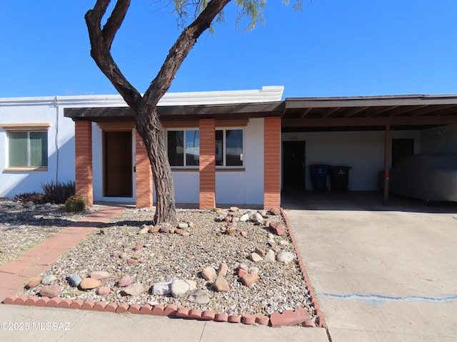 ranch-style home with driveway and an attached carport