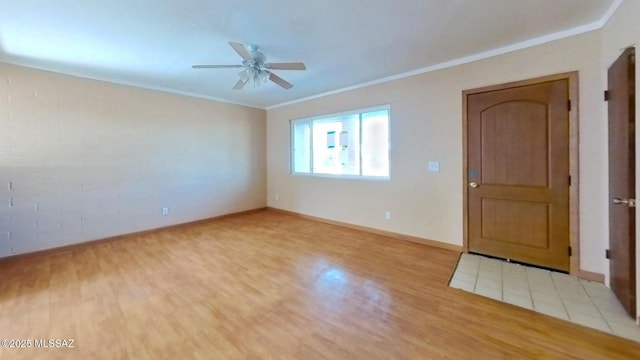 unfurnished room featuring baseboards, light wood-type flooring, a ceiling fan, and crown molding