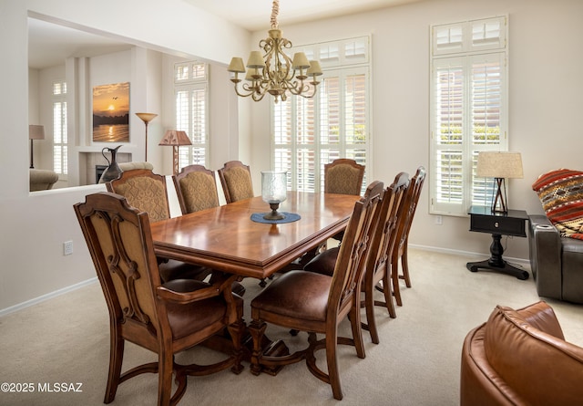 dining area with baseboards, a wealth of natural light, and light colored carpet