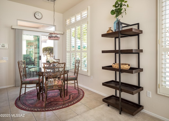 tiled dining area featuring visible vents and baseboards