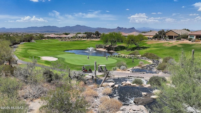 view of home's community featuring view of golf course and a mountain view