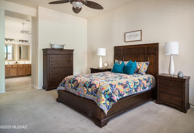 bedroom with ensuite bathroom, ceiling fan, and carpet