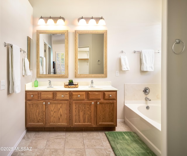 bathroom with double vanity, tile patterned flooring, a sink, and a bath