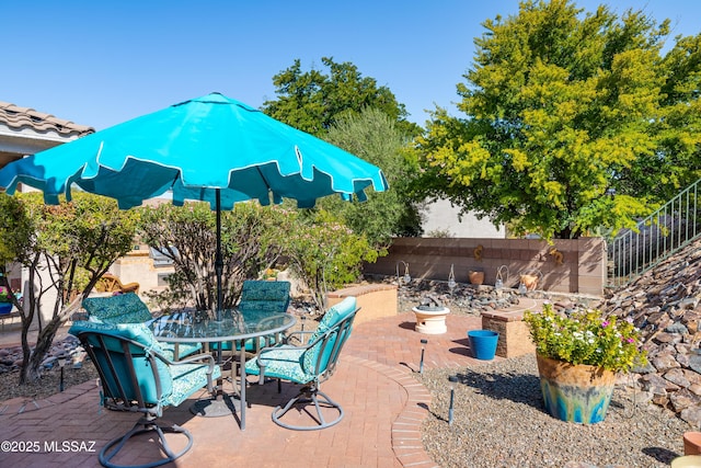 view of patio featuring outdoor dining area and a fenced backyard