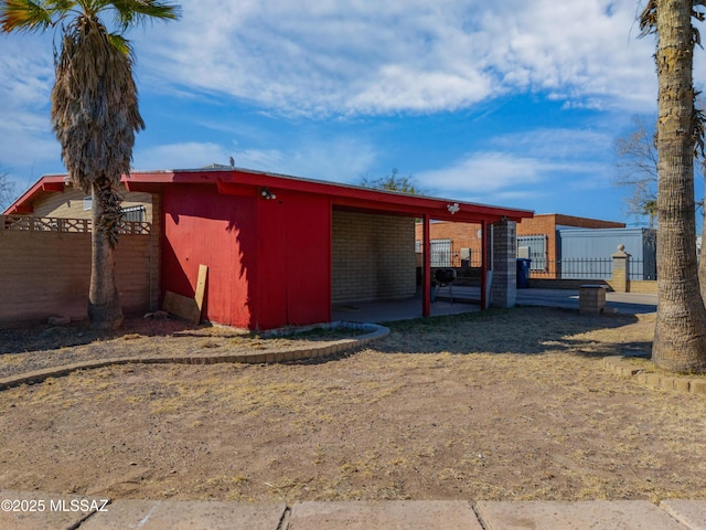 view of outbuilding featuring fence