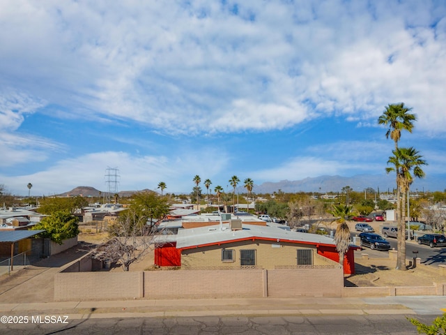 view of front of property featuring fence and a mountain view