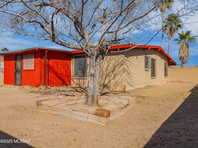 view of property exterior with fence