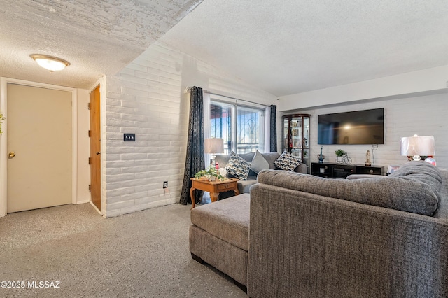 living area with brick wall, vaulted ceiling, and a textured ceiling