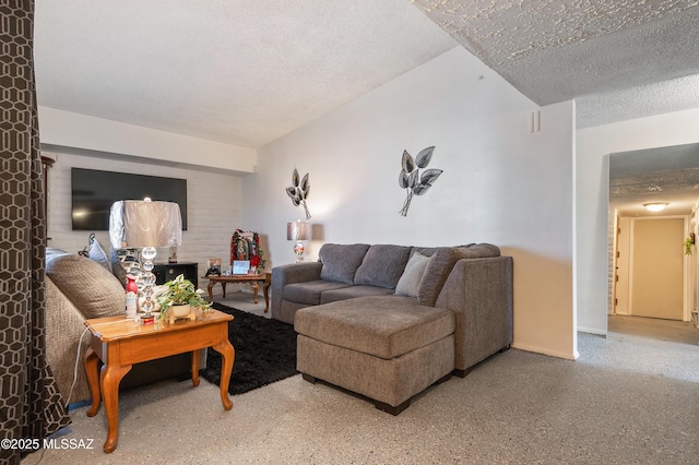 living area with a textured ceiling and speckled floor