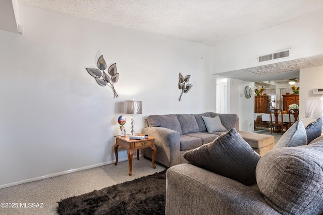 carpeted living area featuring visible vents, a textured ceiling, and baseboards