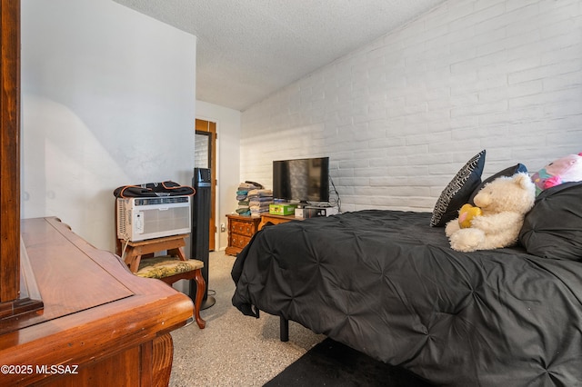 bedroom with light carpet, vaulted ceiling, a textured ceiling, and brick wall