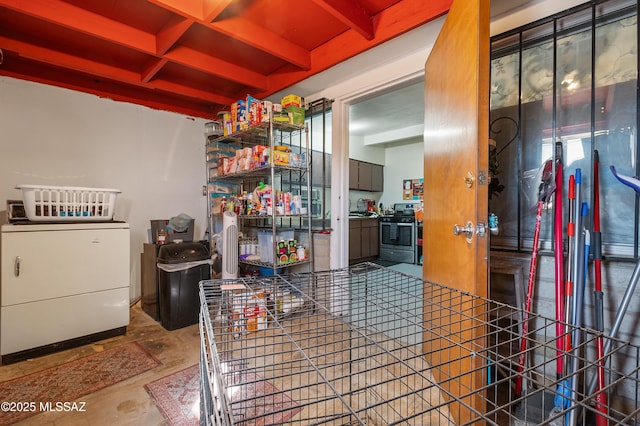 interior space featuring beam ceiling, coffered ceiling, and washer / dryer