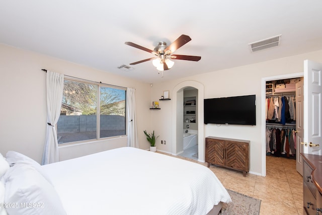 bedroom with a spacious closet, a closet, visible vents, and baseboards