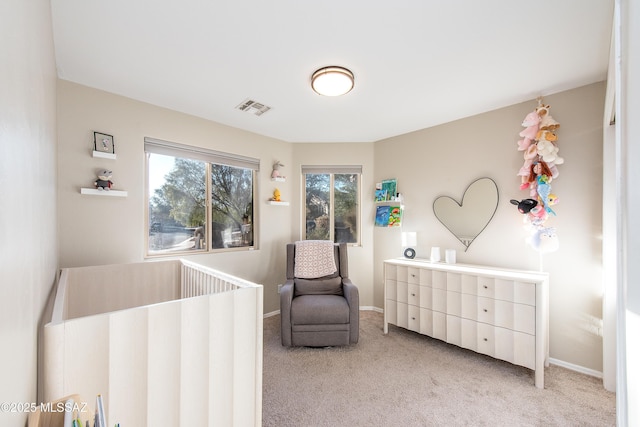 bedroom with light carpet, visible vents, and baseboards