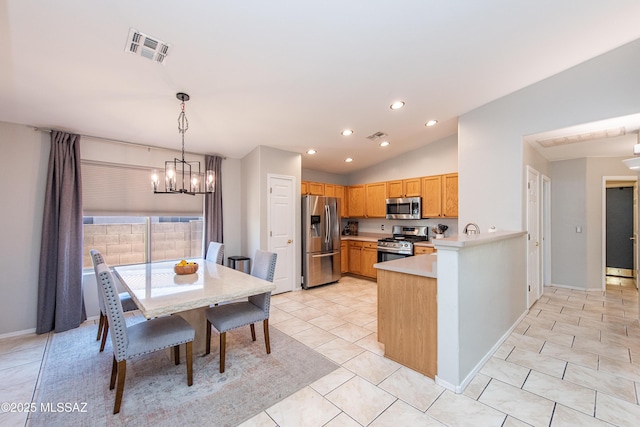 kitchen featuring stainless steel appliances, lofted ceiling, light countertops, hanging light fixtures, and visible vents