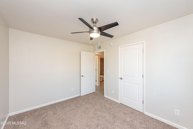 unfurnished bedroom featuring light carpet, a ceiling fan, visible vents, and baseboards